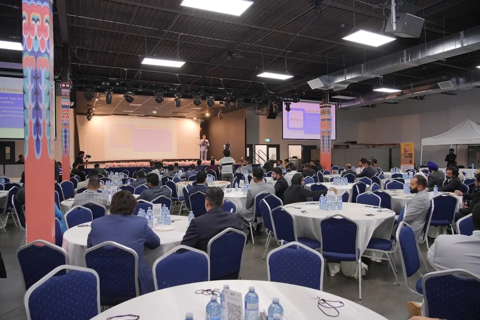 Indian Business Meetup guests gathered at roundtables facing a speaker