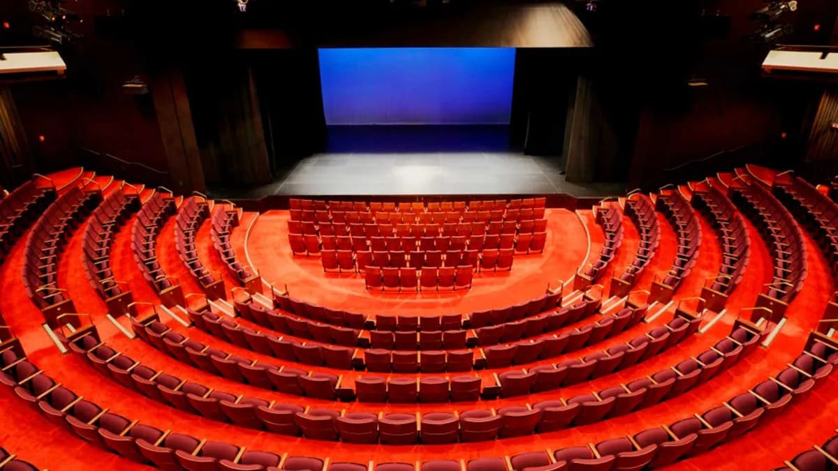 Red semicircular seating and stage in Babs Asper Theatre at the National Arts Centre